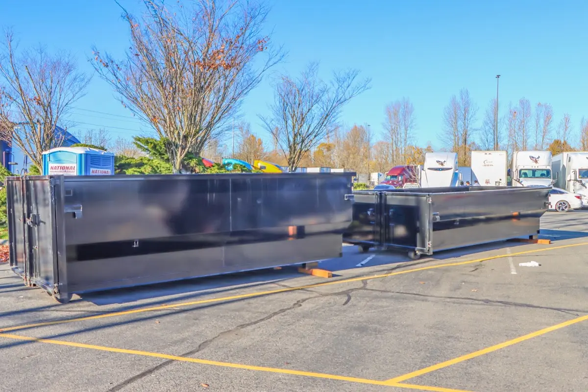 Professional dumpster rental service with roll-off container on residential driveway in South Abington
